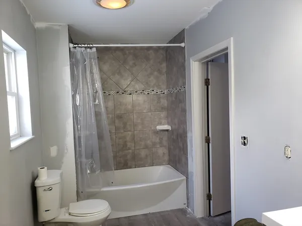 a bathroom with a shower and a toilet