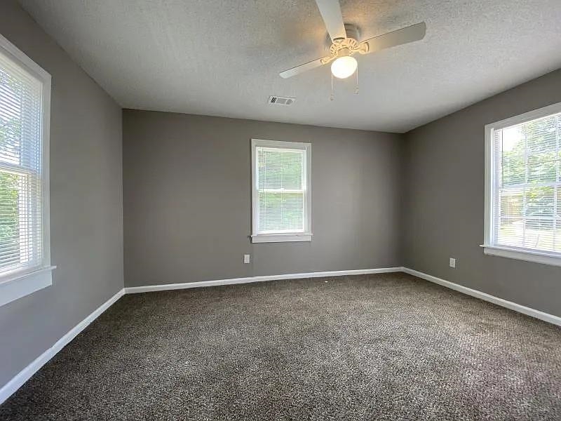 247 Modder Avenue Memphis, TN 38109 - Photo 8 of 8 an empty room with windows and fan