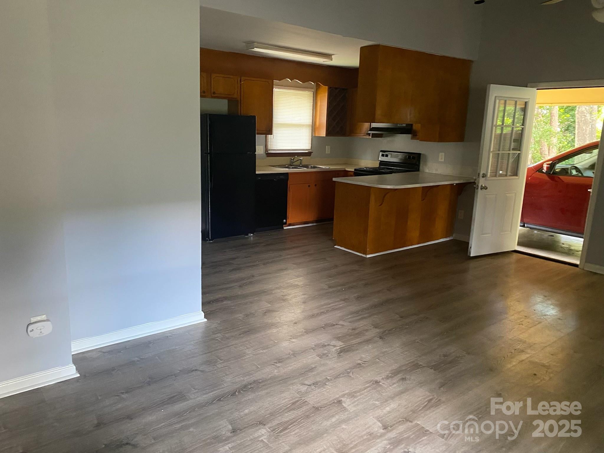 120 West Hudson Street Monroe, NC 28112 - Photo 4 of 9 a kitchen with stainless steel appliances granite countertop a stove a sink and a refrigerator