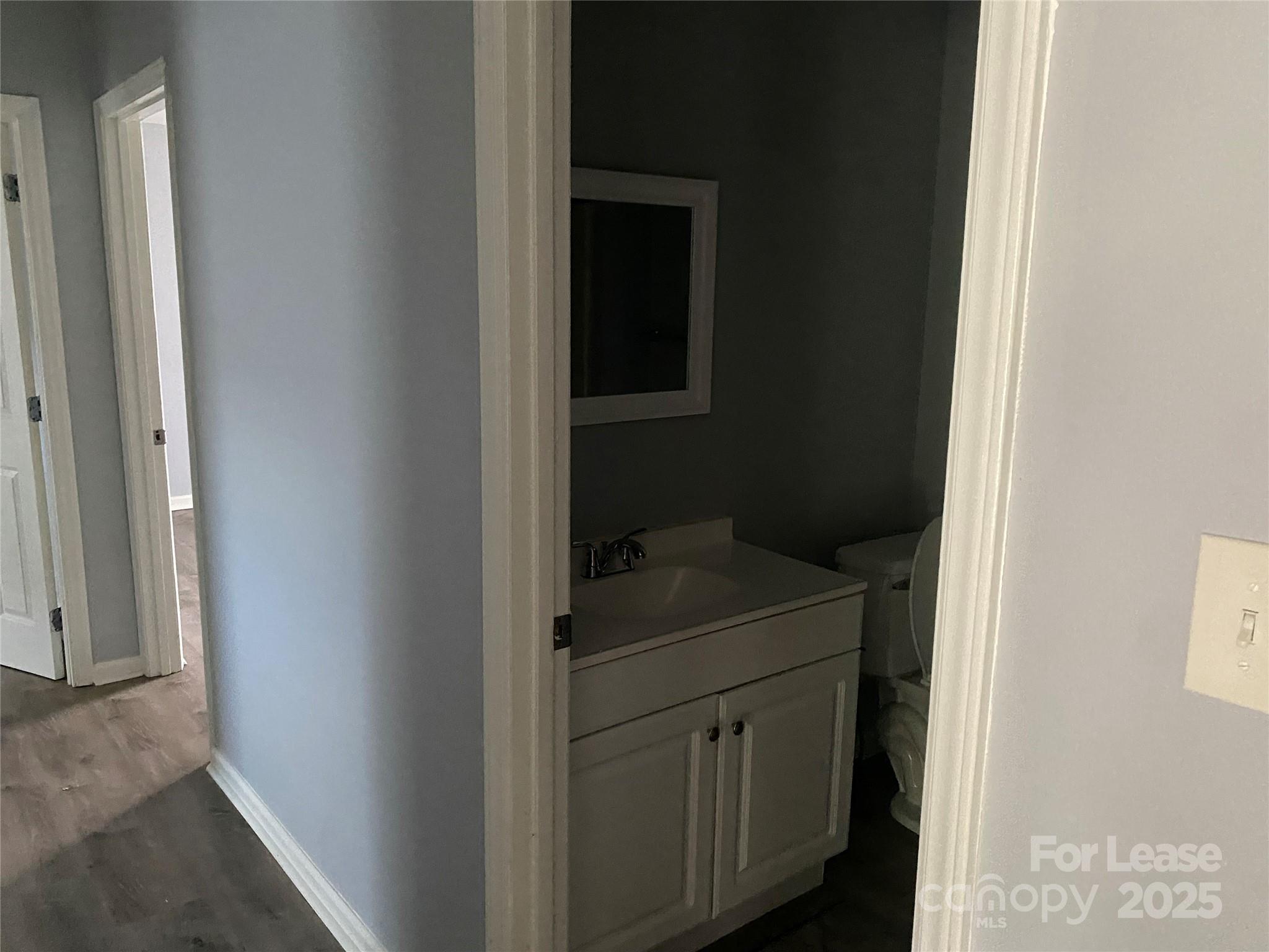 120 West Hudson Street Monroe, NC 28112 - Photo 8 of 9 a bathroom with a sink toilet and vanity