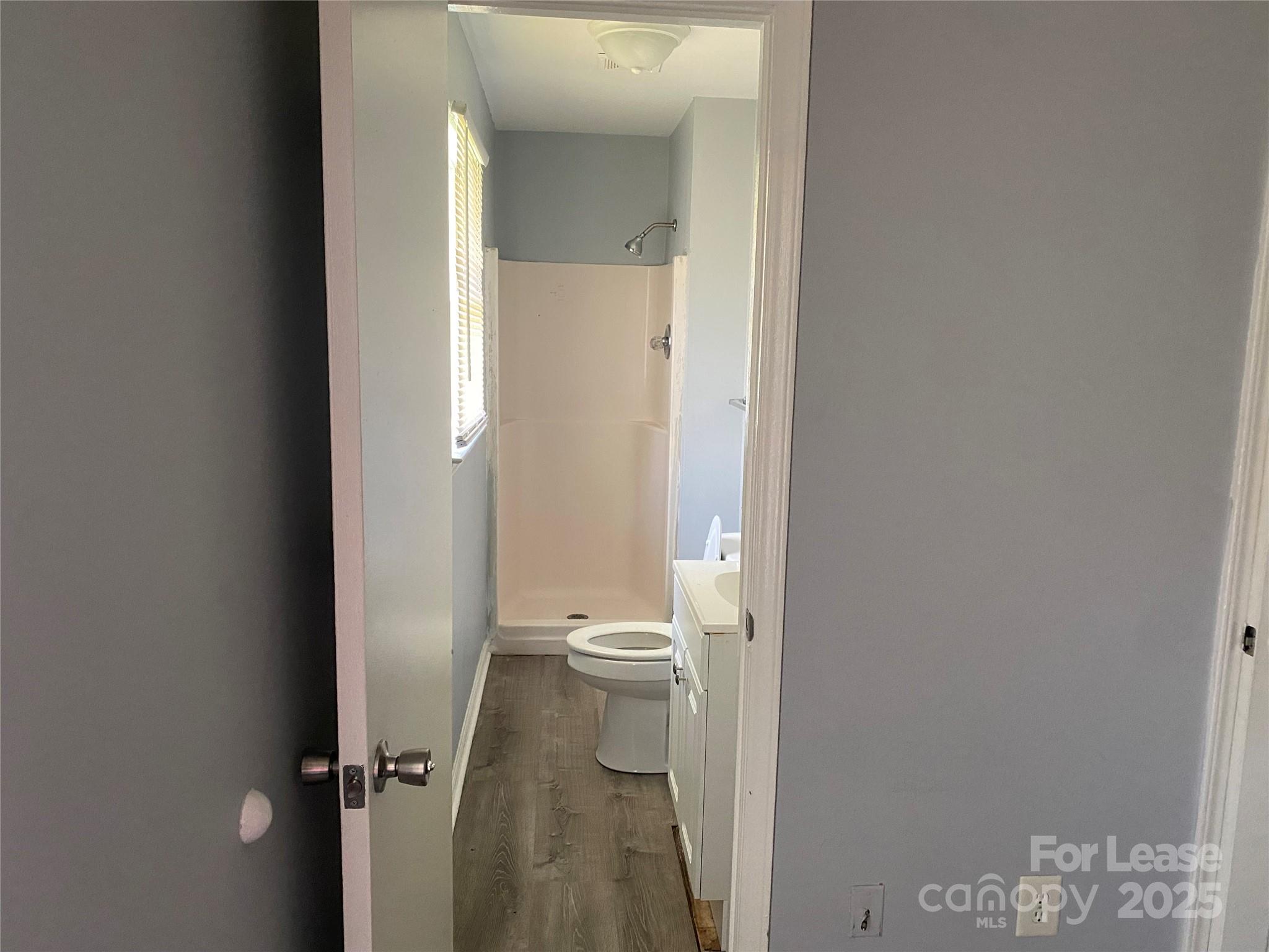 120 West Hudson Street Monroe, NC 28112 - Photo 9 of 9 a bathroom with a granite countertop toilet a sink and a mirror