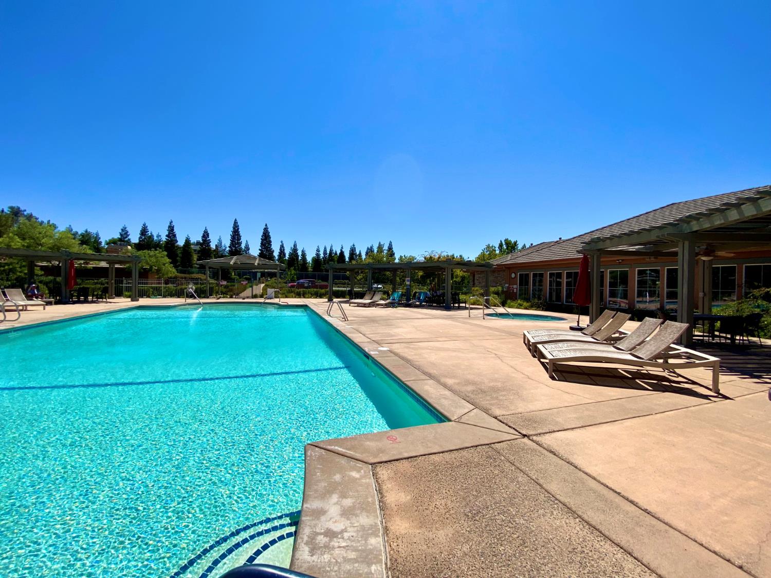 340 Hawk Ridge, Unit 491 Copperopolis, CA 95228 - Photo 24 of 27 a swimming pool with outdoor seating and yard