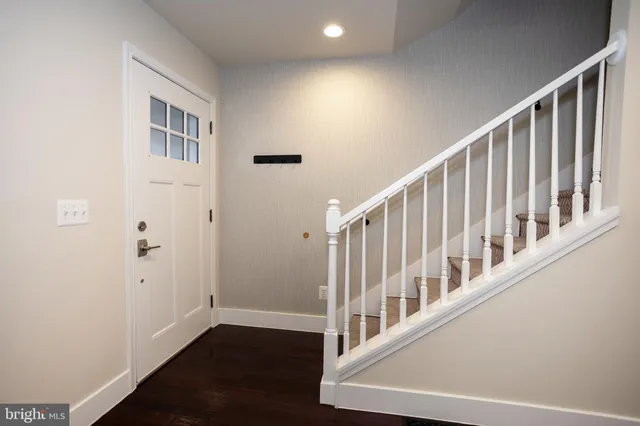 a view of an entryway with wooden floor
