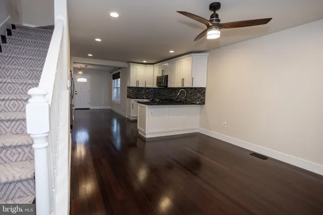 a view of a kitchen with a sink and a stove top oven