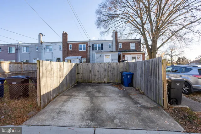 a view of a house with wooden fence