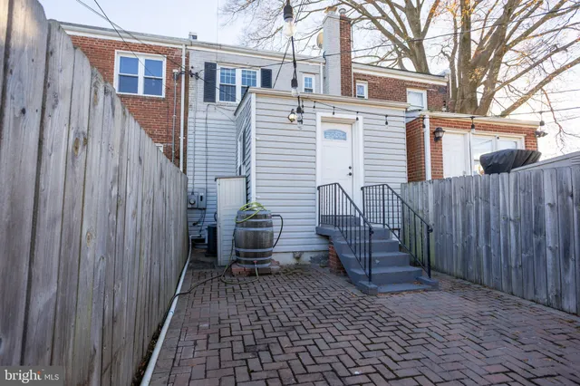 a view of a house with wooden fence
