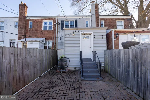 a view of a house with wooden fence