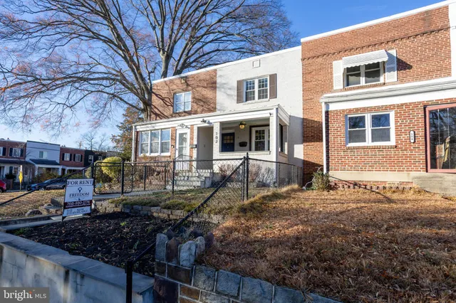 a view of a house with a yard covered in snow