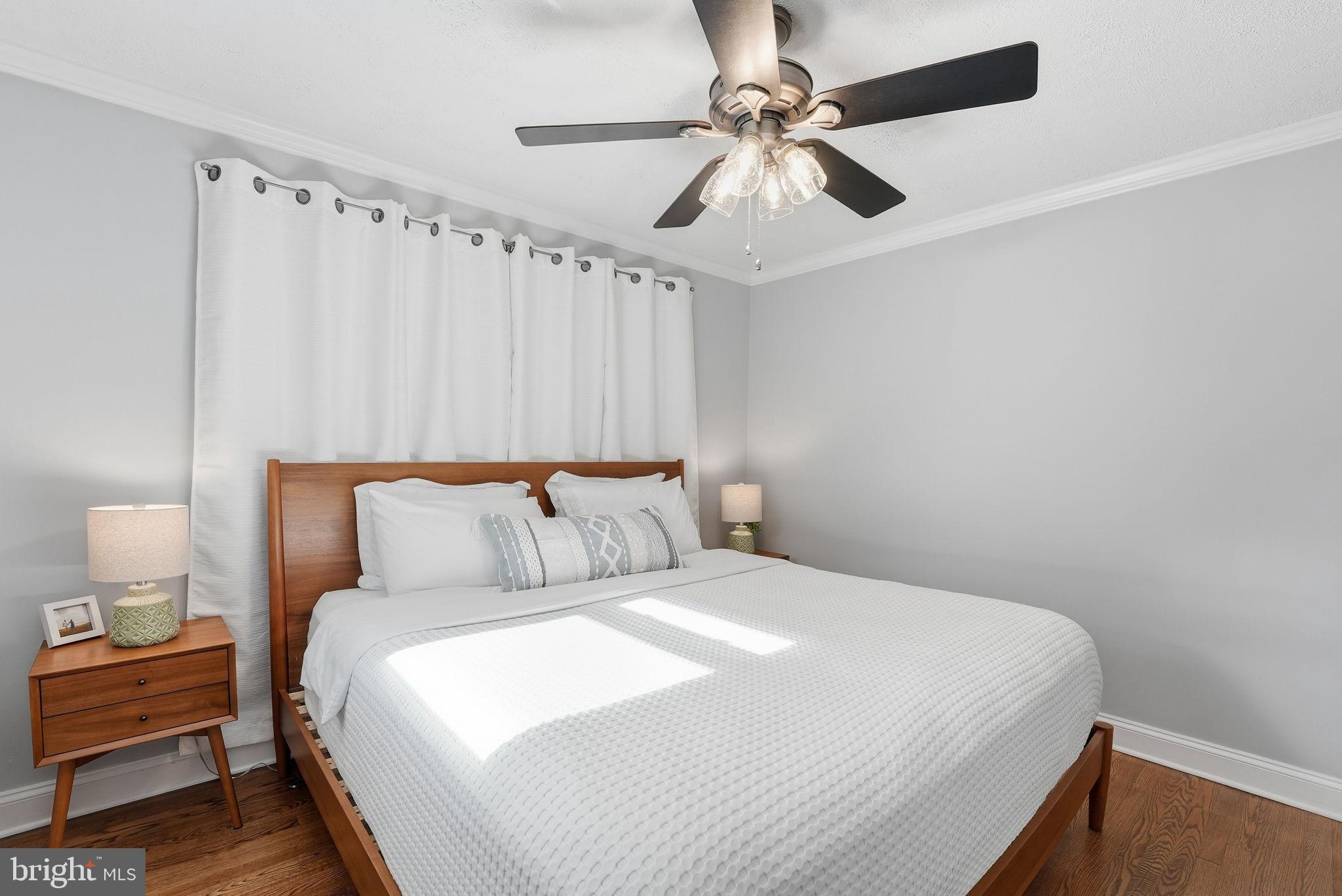 6803 Derrell Court Alexandria, VA 22307 - Photo 17 of 43 a bedroom with a bed and a chandelier