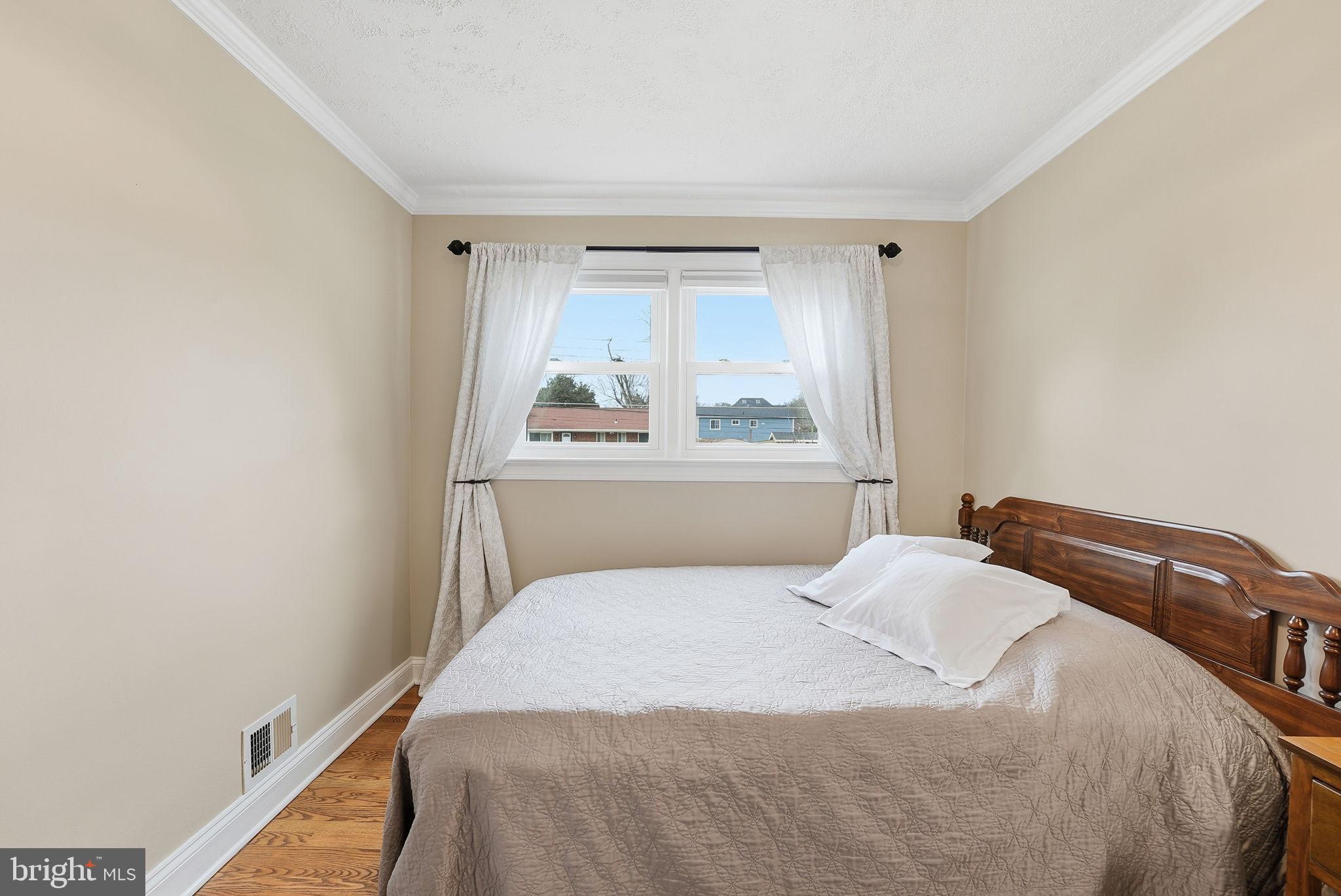 6803 Derrell Court Alexandria, VA 22307 - Photo 20 of 43 a bedroom with a bed and a window