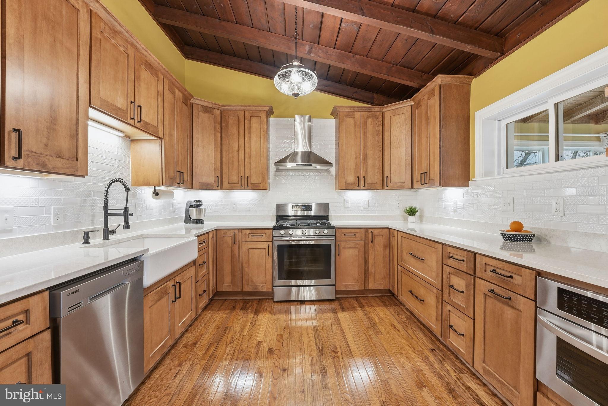6803 Derrell Court Alexandria, VA 22307 - Photo 2 of 43 a kitchen with granite countertop a sink cabinets stainless steel appliances and a counter top space