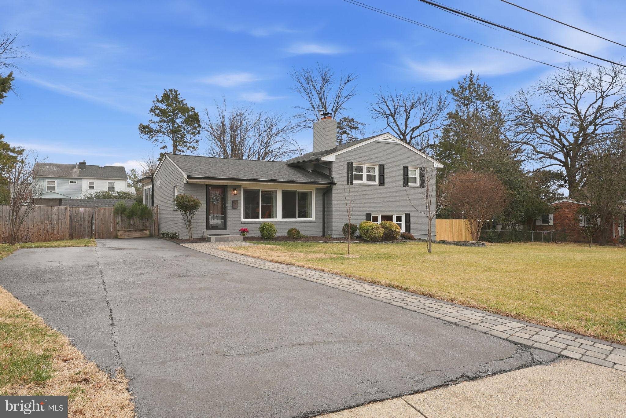 6803 Derrell Court Alexandria, VA 22307 - Photo 38 of 43 a front view of a house with a yard and garage
