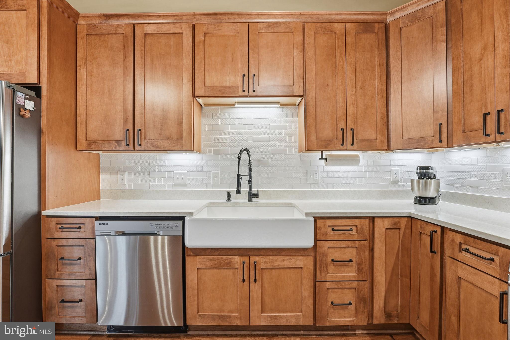 6803 Derrell Court Alexandria, VA 22307 - Photo 4 of 43 a kitchen with granite countertop a sink cabinets and stainless steel appliances