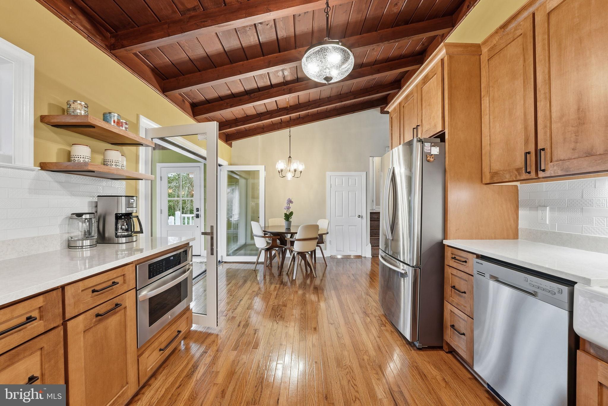 6803 Derrell Court Alexandria, VA 22307 - Photo 5 of 43 a kitchen with wooden floors and wooden cabinets