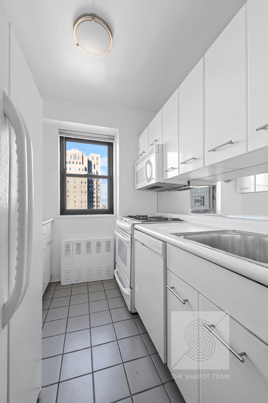 345 East 80th Street, Unit 30K Manhattan, NY 10075 - Photo 11 of 12 a kitchen with a sink and cabinets