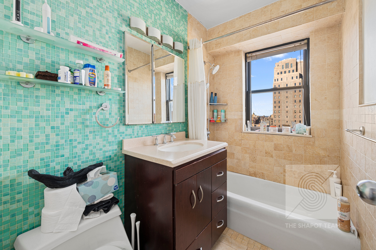 345 East 80th Street, Unit 30K Manhattan, NY 10075 - Photo 3 of 12 a bathroom with a sink mirror toilet and bathtub