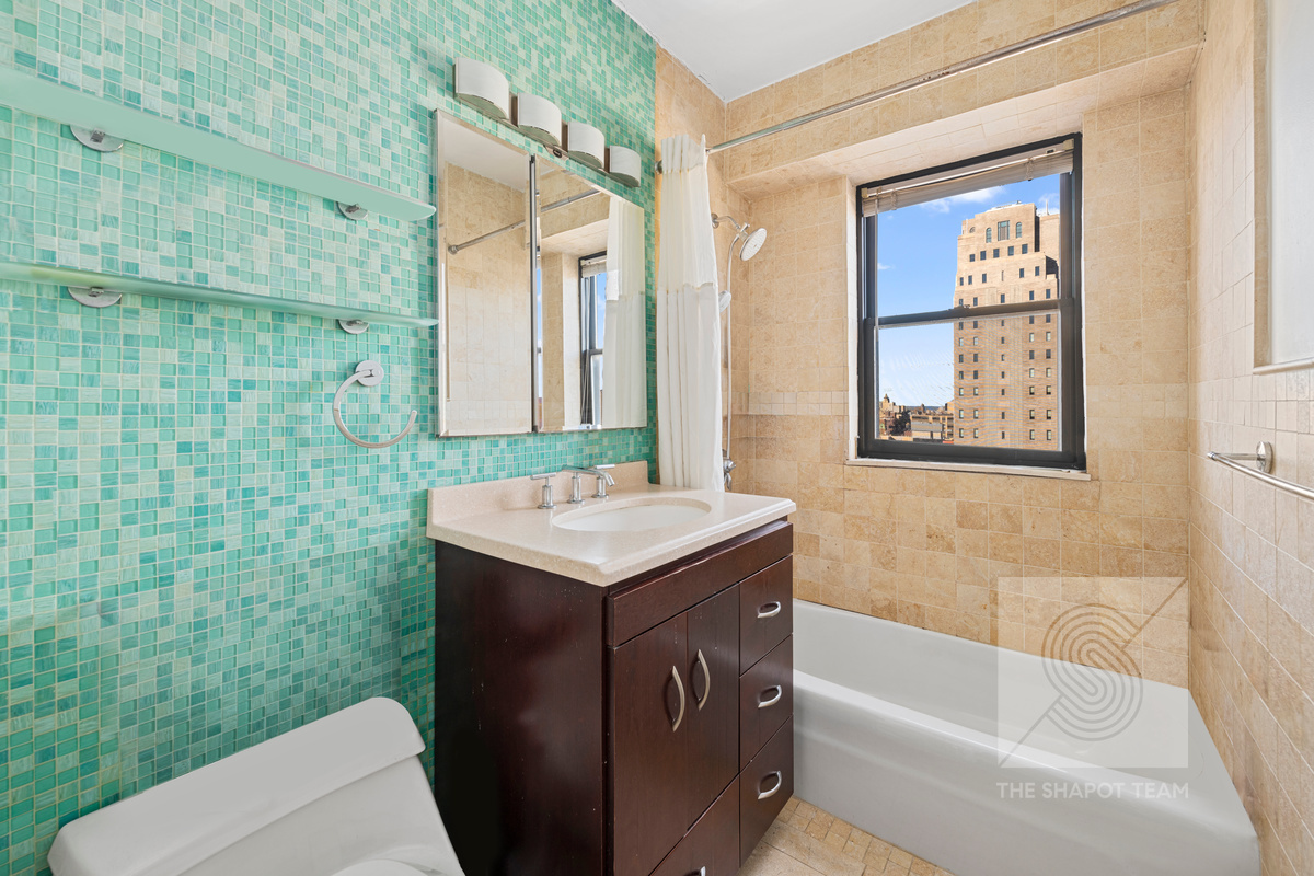 345 East 80th Street, Unit 30K Manhattan, NY 10075 - Photo 4 of 12 a bathroom with a sink a toilet and shower