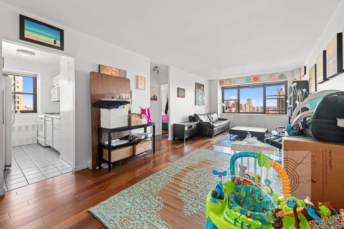 345 East 80th Street, Unit 30K Manhattan, NY 10075 - Photo 8 of 12 a living room filled with furniture and a couch