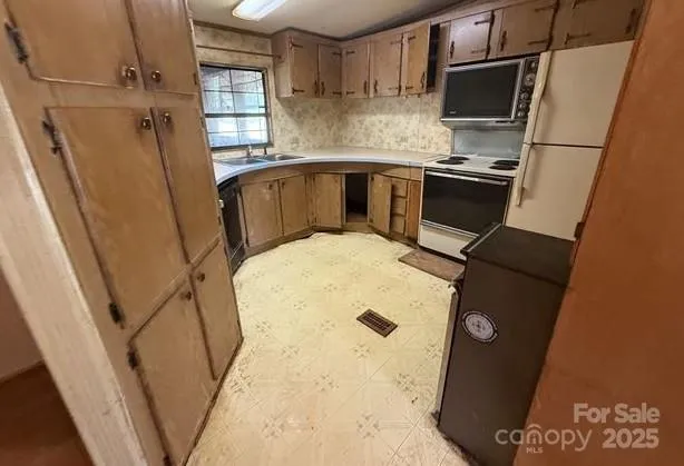 a kitchen with a sink appliances and cabinets