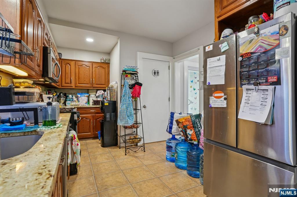 228 Totowa Road Totowa, NJ 07512 - Photo 11 of 39 a utility room with stainless steel appliances lots of furniture and toys