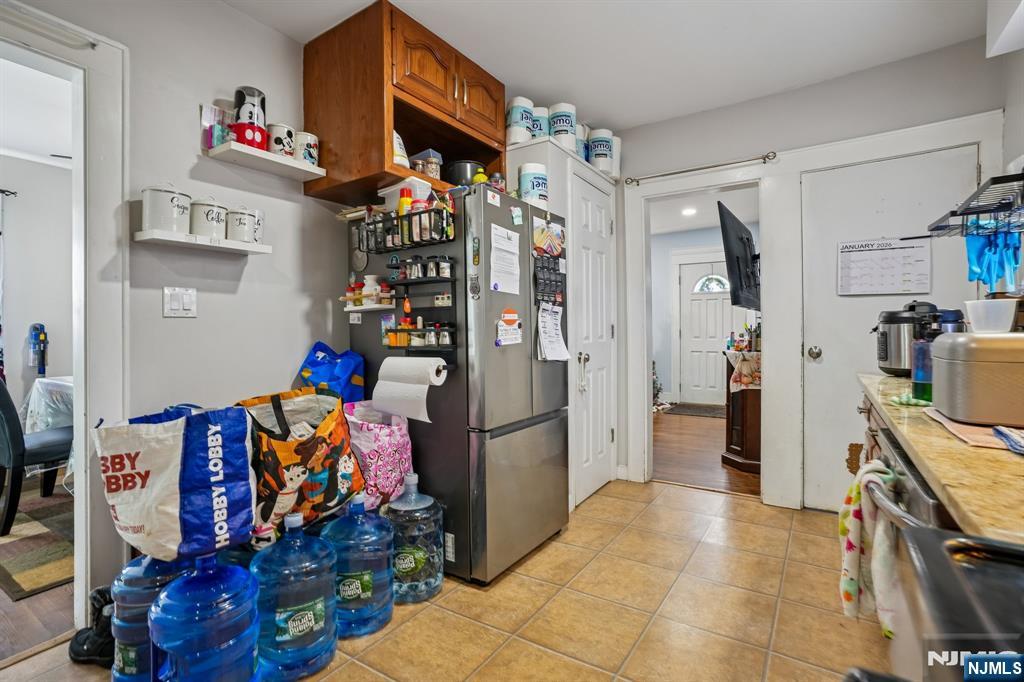 228 Totowa Road Totowa, NJ 07512 - Photo 12 of 39 a view of a kitchen with fridge and workspace