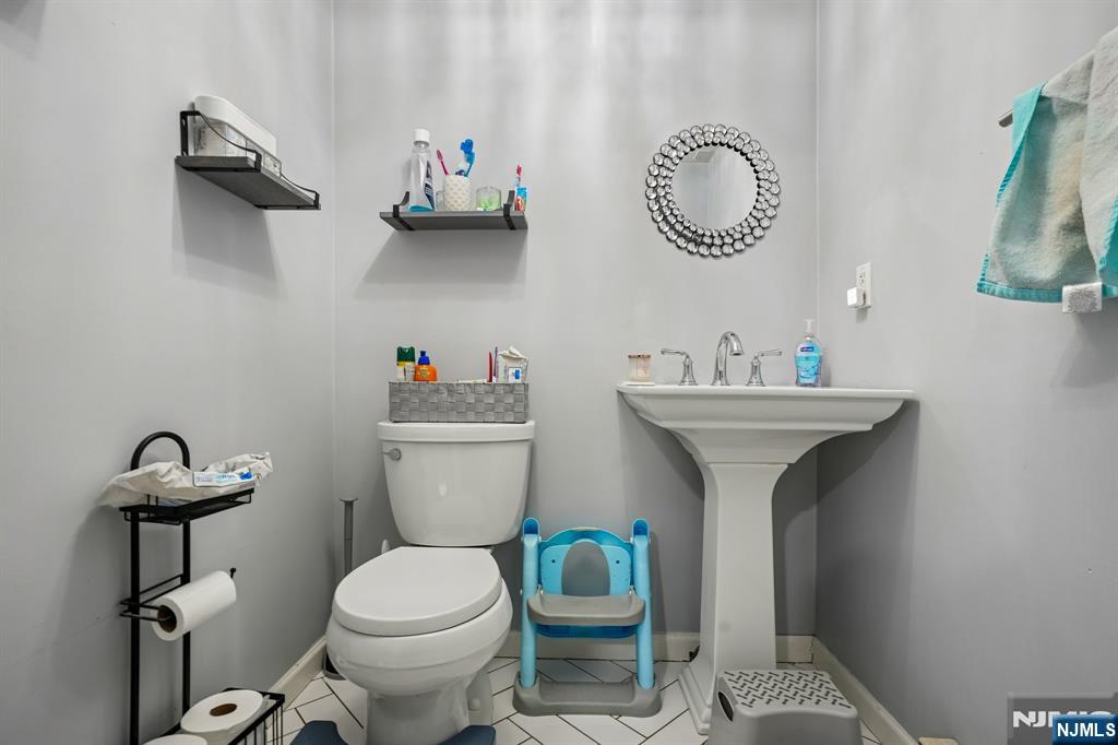 228 Totowa Road Totowa, NJ 07512 - Photo 29 of 39 a bathroom with a sink mirror and toilet