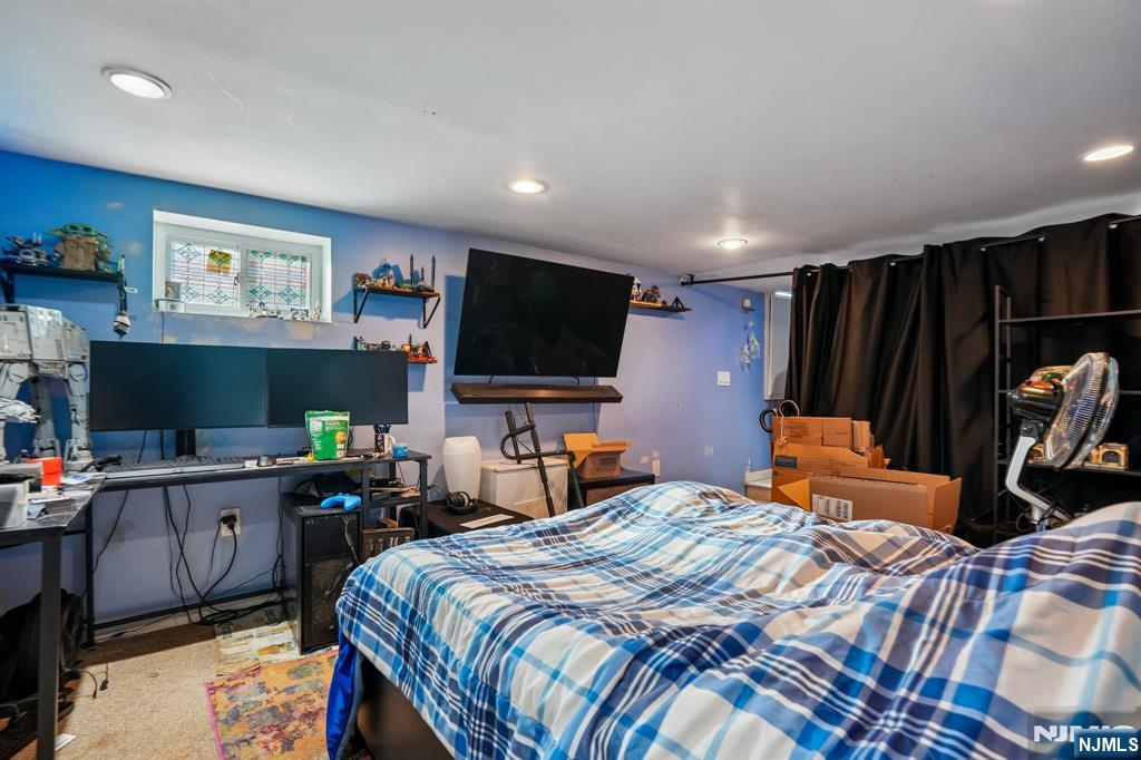 228 Totowa Road Totowa, NJ 07512 - Photo 31 of 39 a bedroom with a bed and a flat screen tv