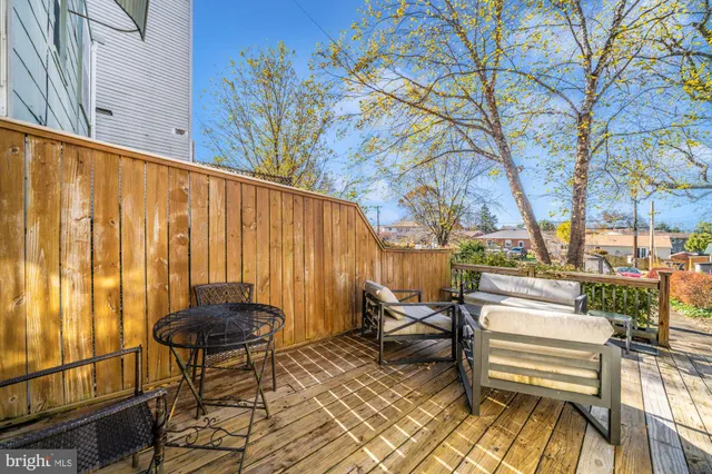 a view of a swimming pool with a bench and trees