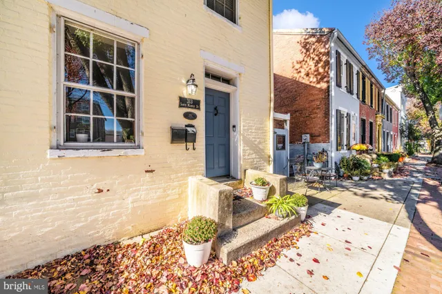 a front view of a house with outdoor seating