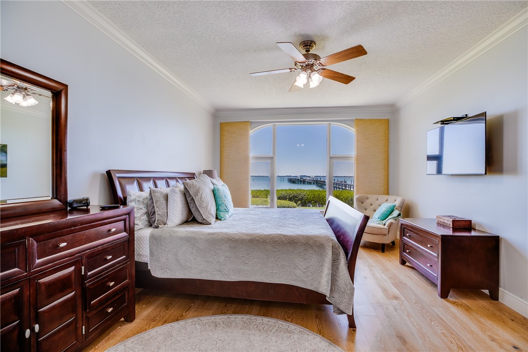 1701 Gulfstream Avenue, Unit 719 Fort Pierce, FL 34949 - Photo 17 of 36 a bedroom with a bed a desk and chair with a mirror