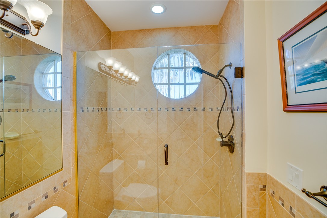1701 Gulfstream Avenue, Unit 719 Fort Pierce, FL 34949 - Photo 23 of 36 a bathroom with a mirror sink and glass door