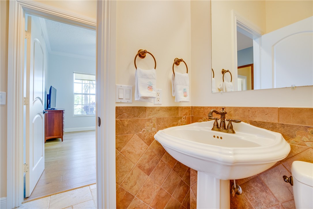 1701 Gulfstream Avenue, Unit 719 Fort Pierce, FL 34949 - Photo 25 of 36 a bathroom with a sink and a mirror