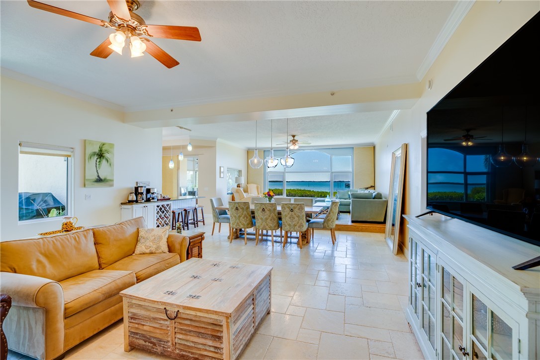 1701 Gulfstream Avenue, Unit 719 Fort Pierce, FL 34949 - Photo 7 of 36 a living room with furniture and a flat screen tv