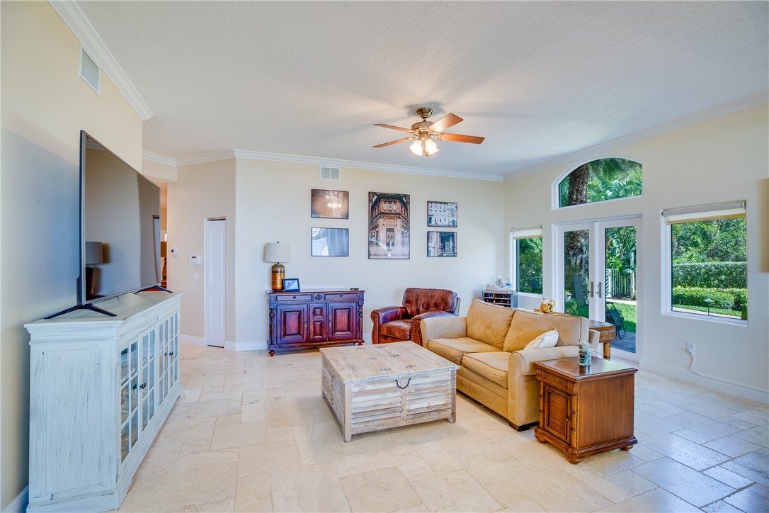 1701 Gulfstream Avenue, Unit 719 Fort Pierce, FL 34949 - Photo 8 of 36 a living room with furniture fireplace and a large window