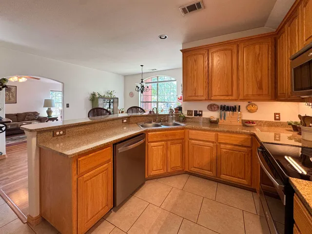 a kitchen with a sink stove top oven and cabinets
