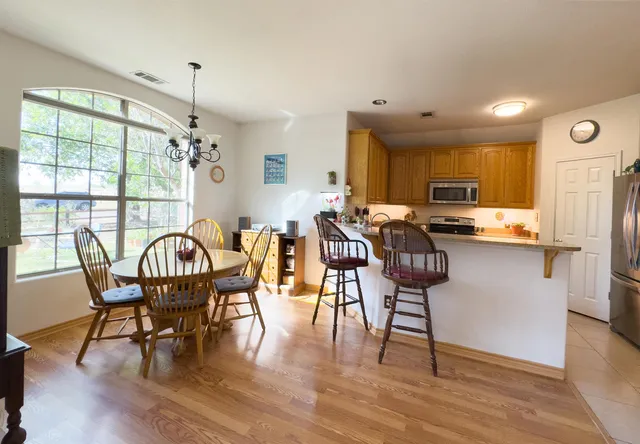 a view of a dining room with furniture window and wooden floor