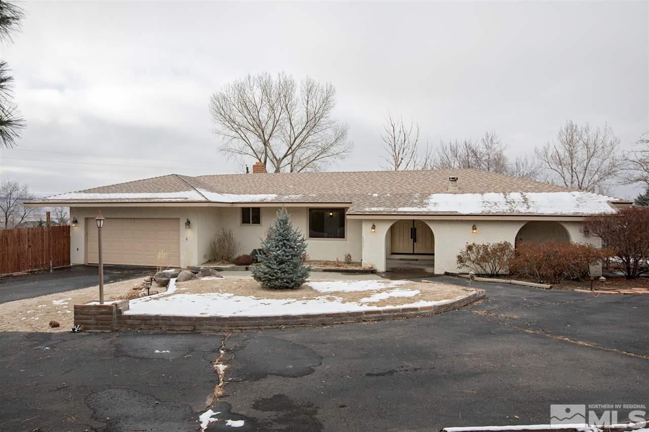 13965 Rancheros Drive Reno, NV 89521 - Photo 1 of 25 a front view of house with yard outdoor seating and garage