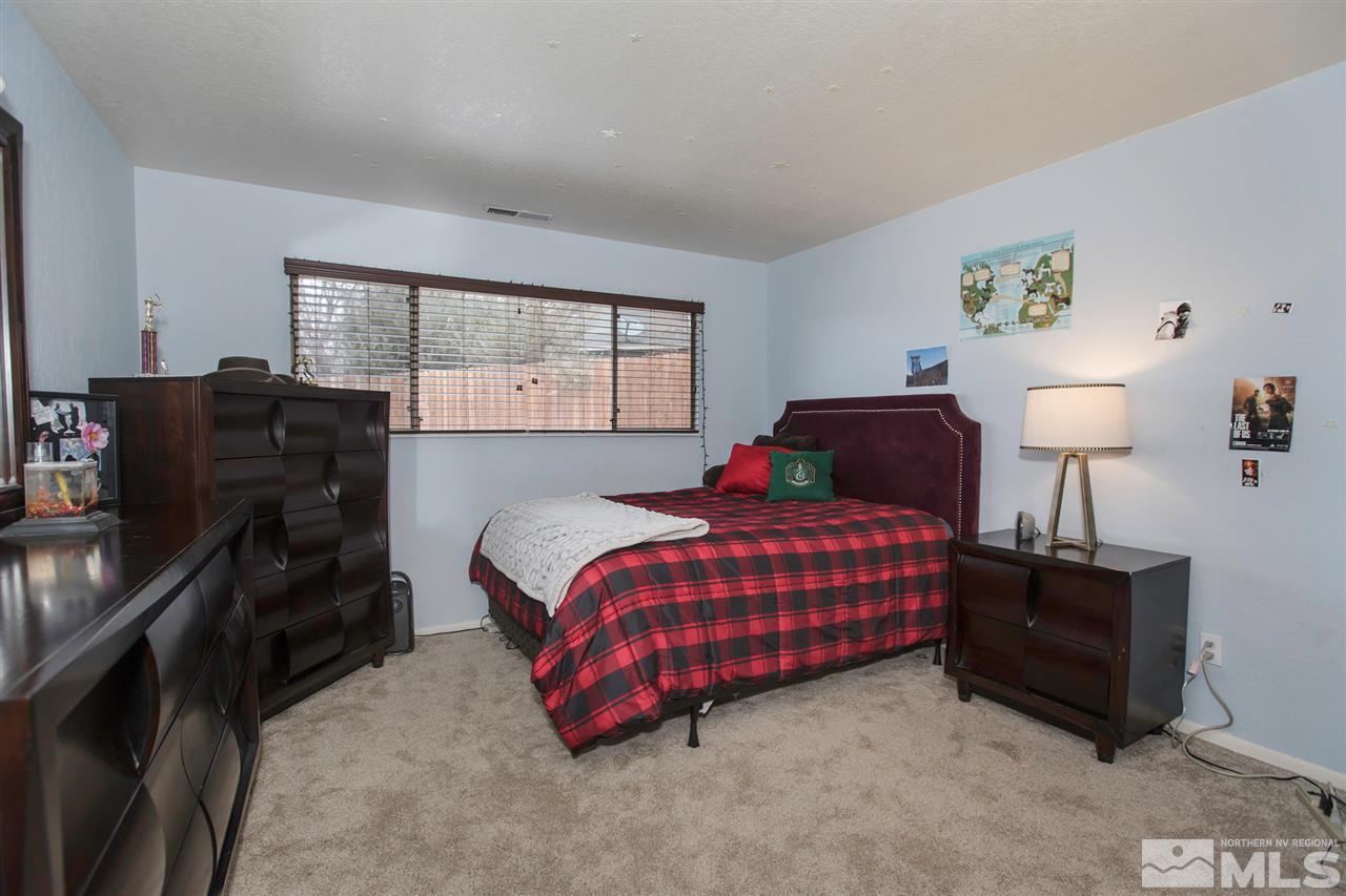 13965 Rancheros Drive Reno, NV 89521 - Photo 11 of 25 a bedroom with a bed and wooden floor
