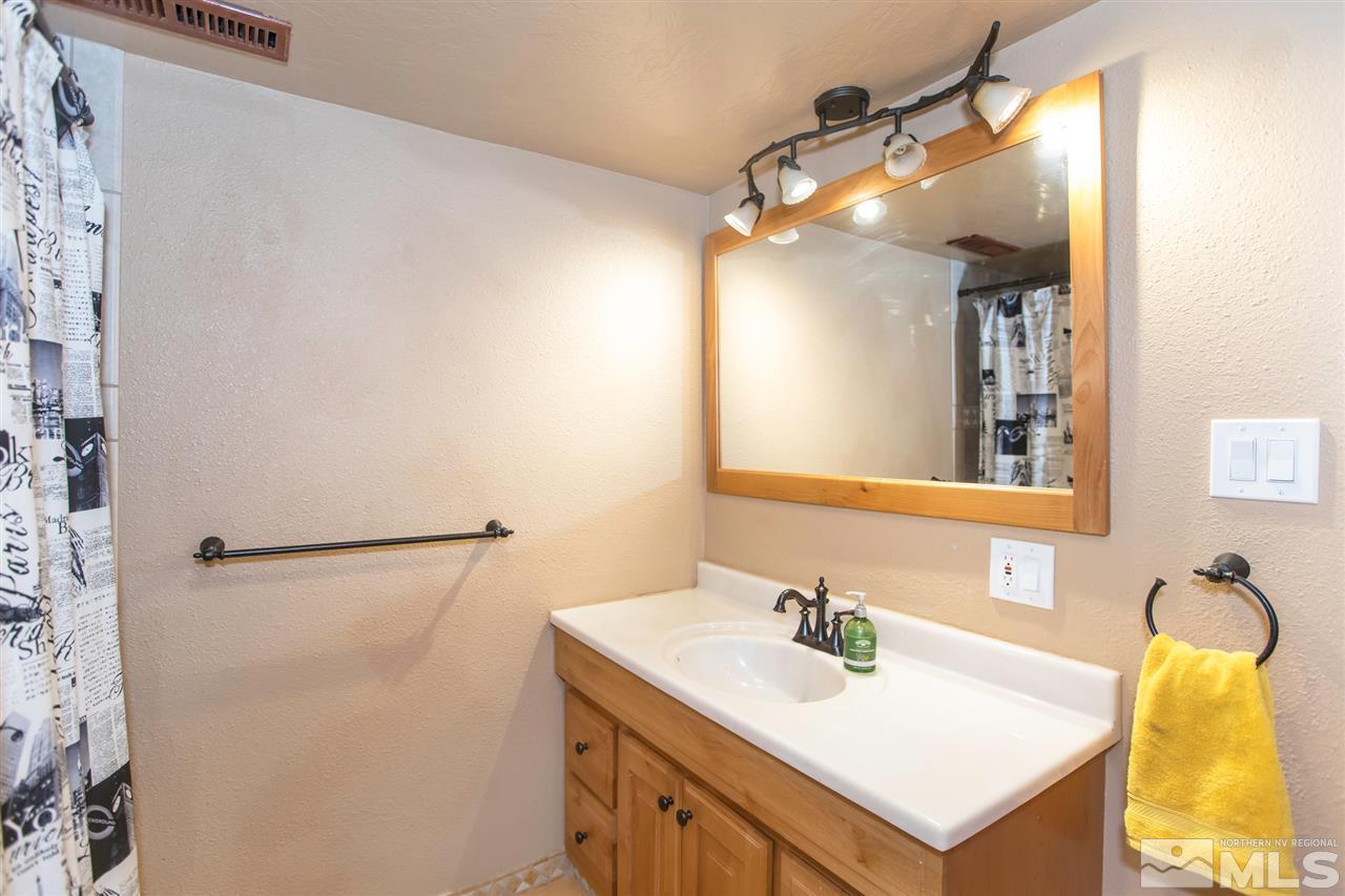 13965 Rancheros Drive Reno, NV 89521 - Photo 12 of 25 a bathroom with a sink vanity and a mirror