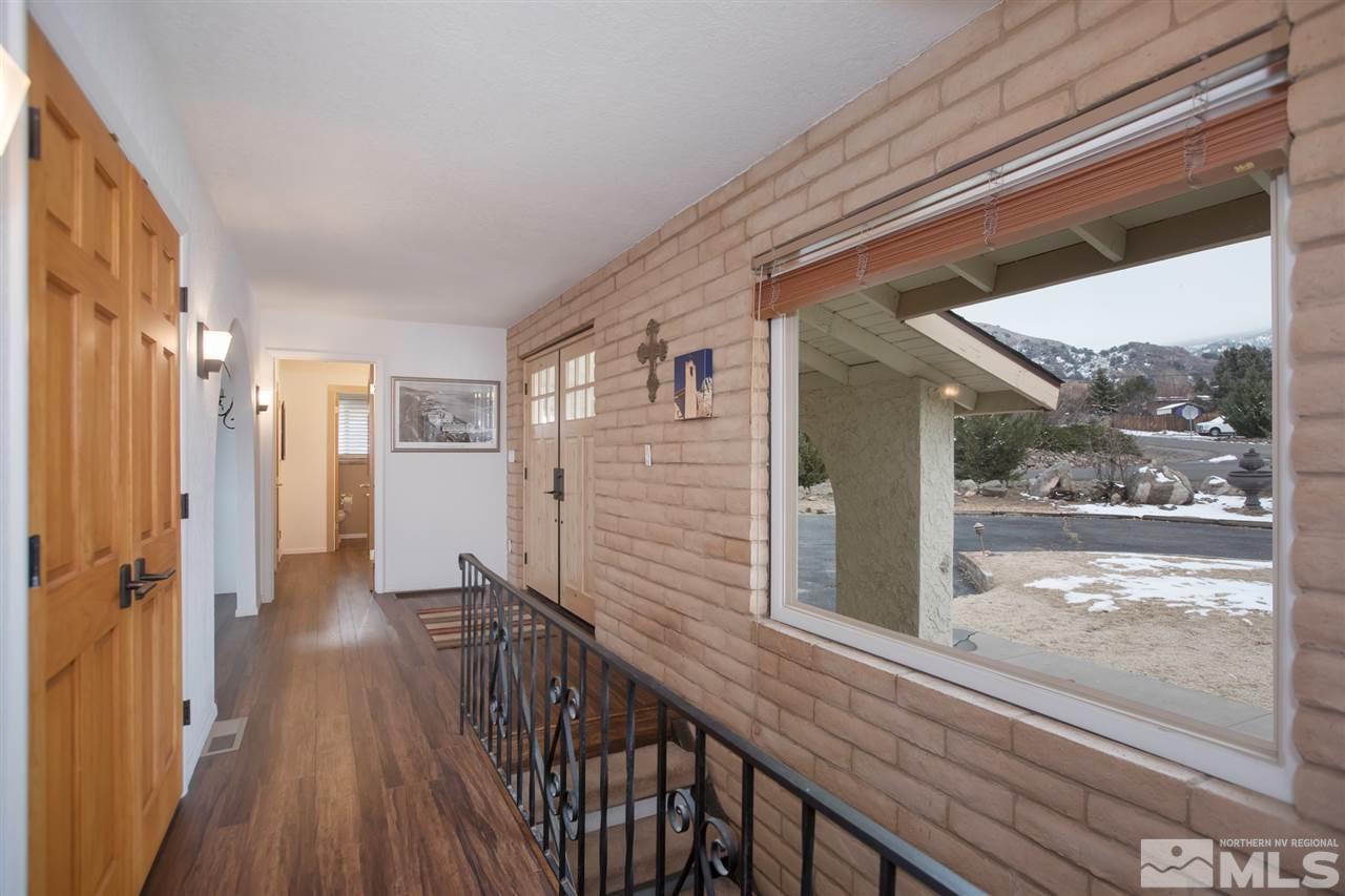 13965 Rancheros Drive Reno, NV 89521 - Photo 3 of 25 a view of a balcony with wooden floor and fence