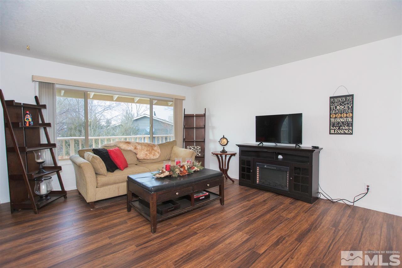 13965 Rancheros Drive Reno, NV 89521 - Photo 4 of 25 a living room with furniture and a flat screen tv