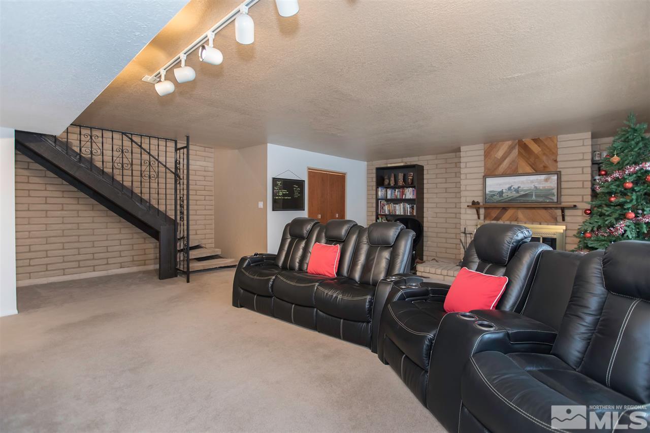 13965 Rancheros Drive Reno, NV 89521 - Photo 8 of 25 a living room with furniture and a flat screen tv
