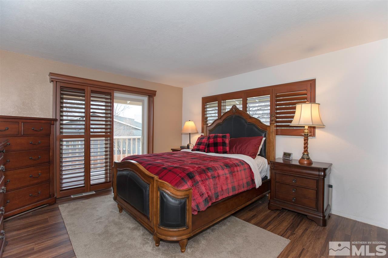 13965 Rancheros Drive Reno, NV 89521 - Photo 9 of 25 a bed sitting in a bedroom next to a window
