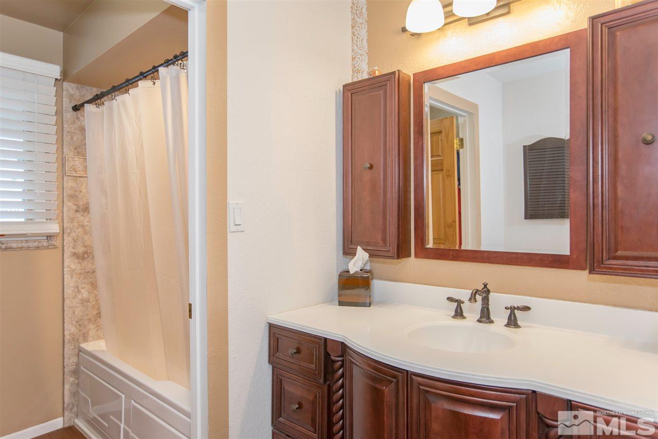 13965 Rancheros Drive Reno, NV 89521 - Photo 10 of 25 a bathroom with a sink and a mirror