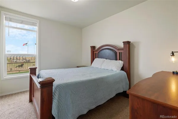 a bedroom with a bed and mirror on dresser