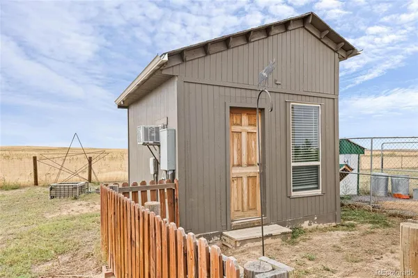 a view of a house with a wooden fence