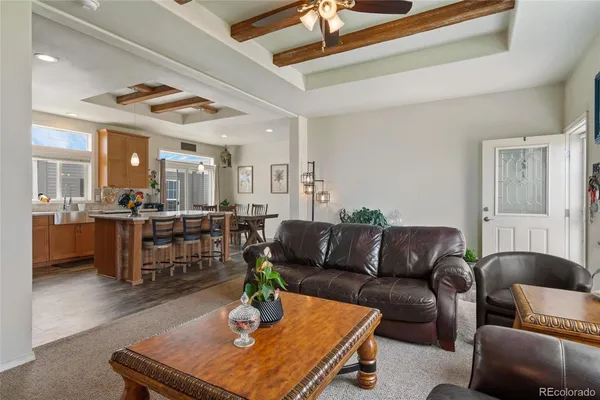 a dining room with stainless steel appliances granite countertop a stove and a refrigerator