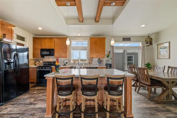 a kitchen with stainless steel appliances granite countertop a sink a stove and a refrigerator