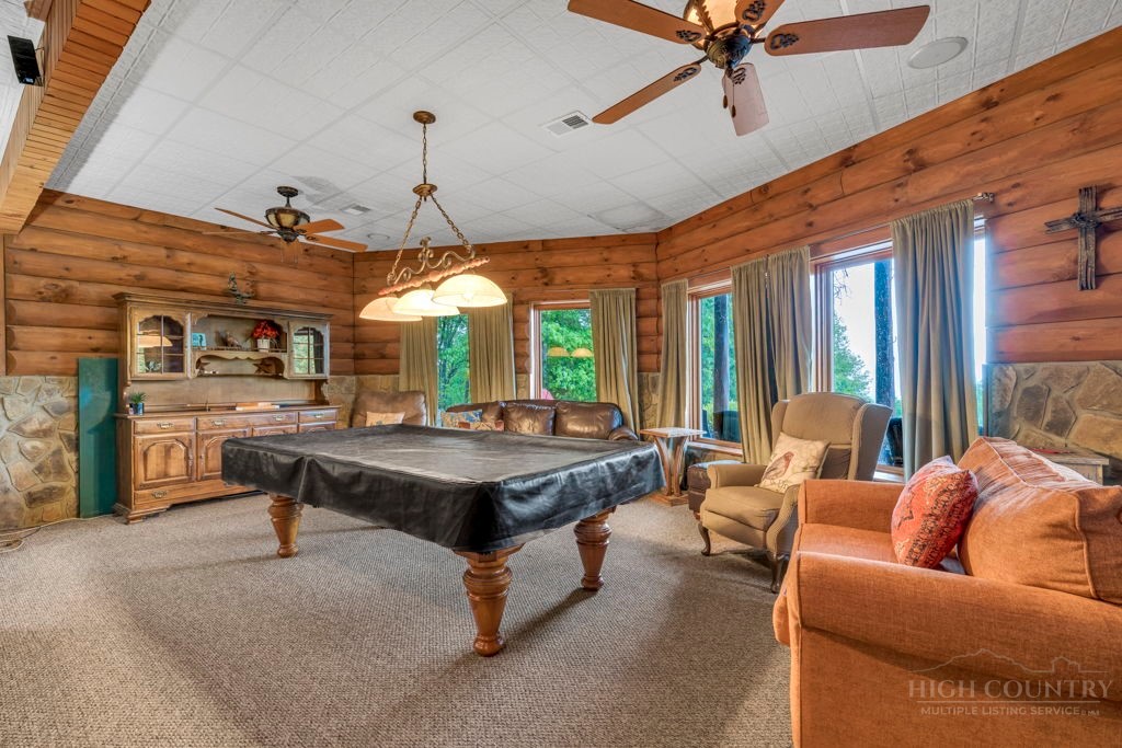 160 Outback Road Ferguson, NC 28624 - Photo 35 of 49 a living room with furniture a fireplace and a chandelier