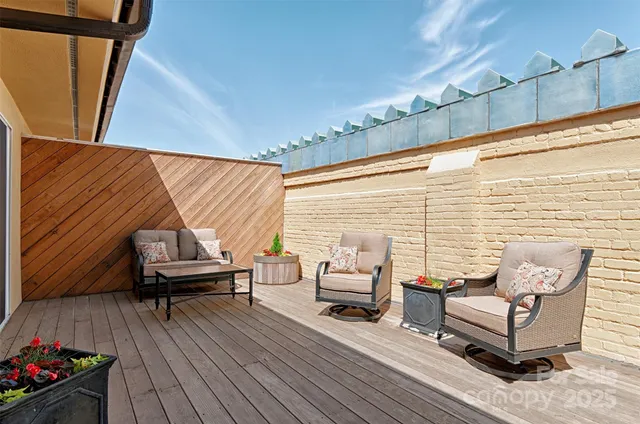 a view of a two chairs in the balcony